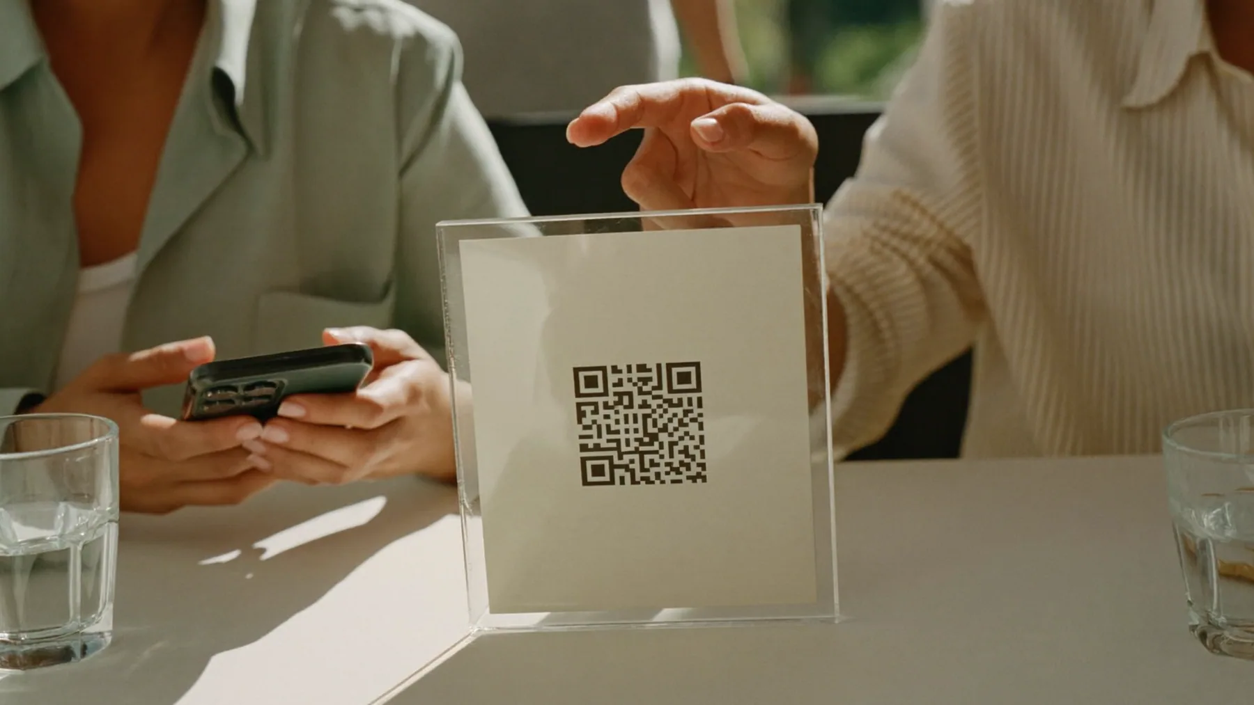 Dos comensales pidiendo desde el celular con el QR de la mesa